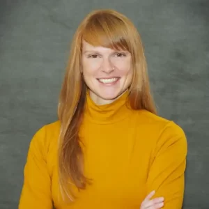 Portrait of a woman with a yellow turtleneck and long blond hair