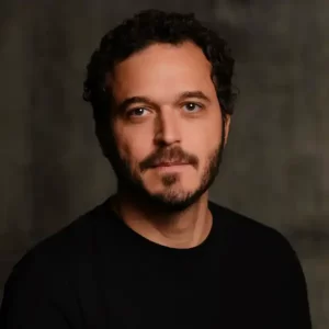 Studio portrait of a man with dark hair, beard and shirt
