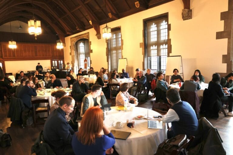 People around tables in a large hall
