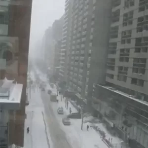 Snowy strret and row of apt buildings