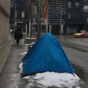 Tent on sidewalk with snow