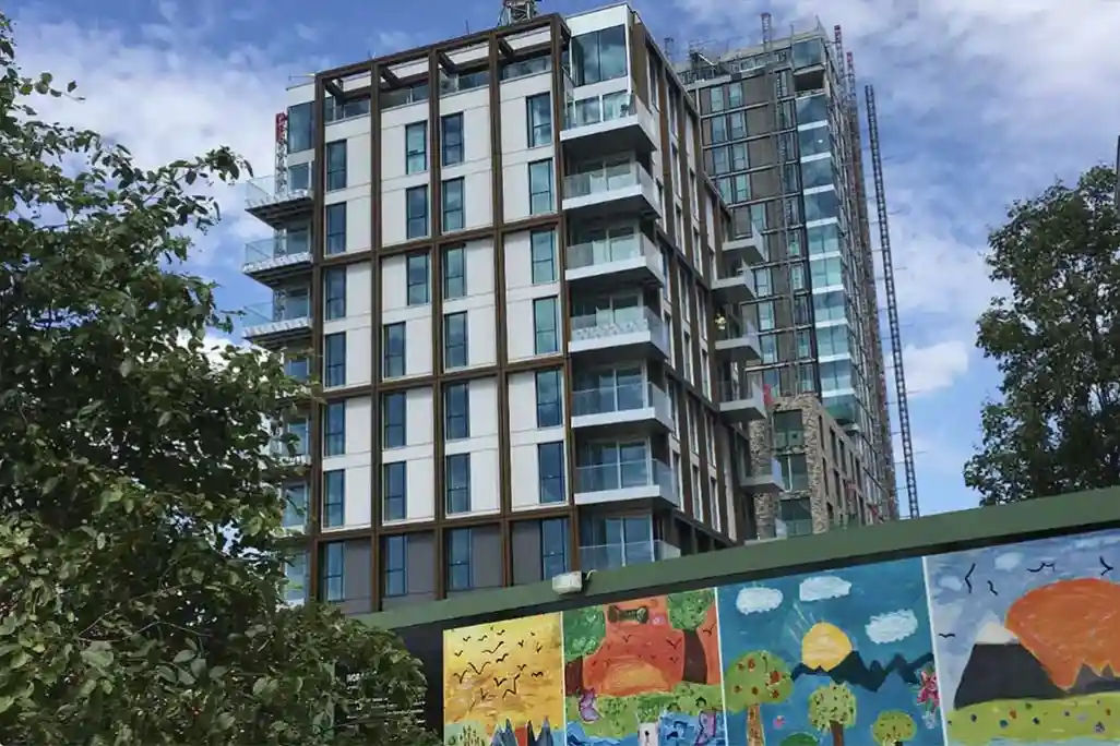 New mid-rise apartment building with a mural outside